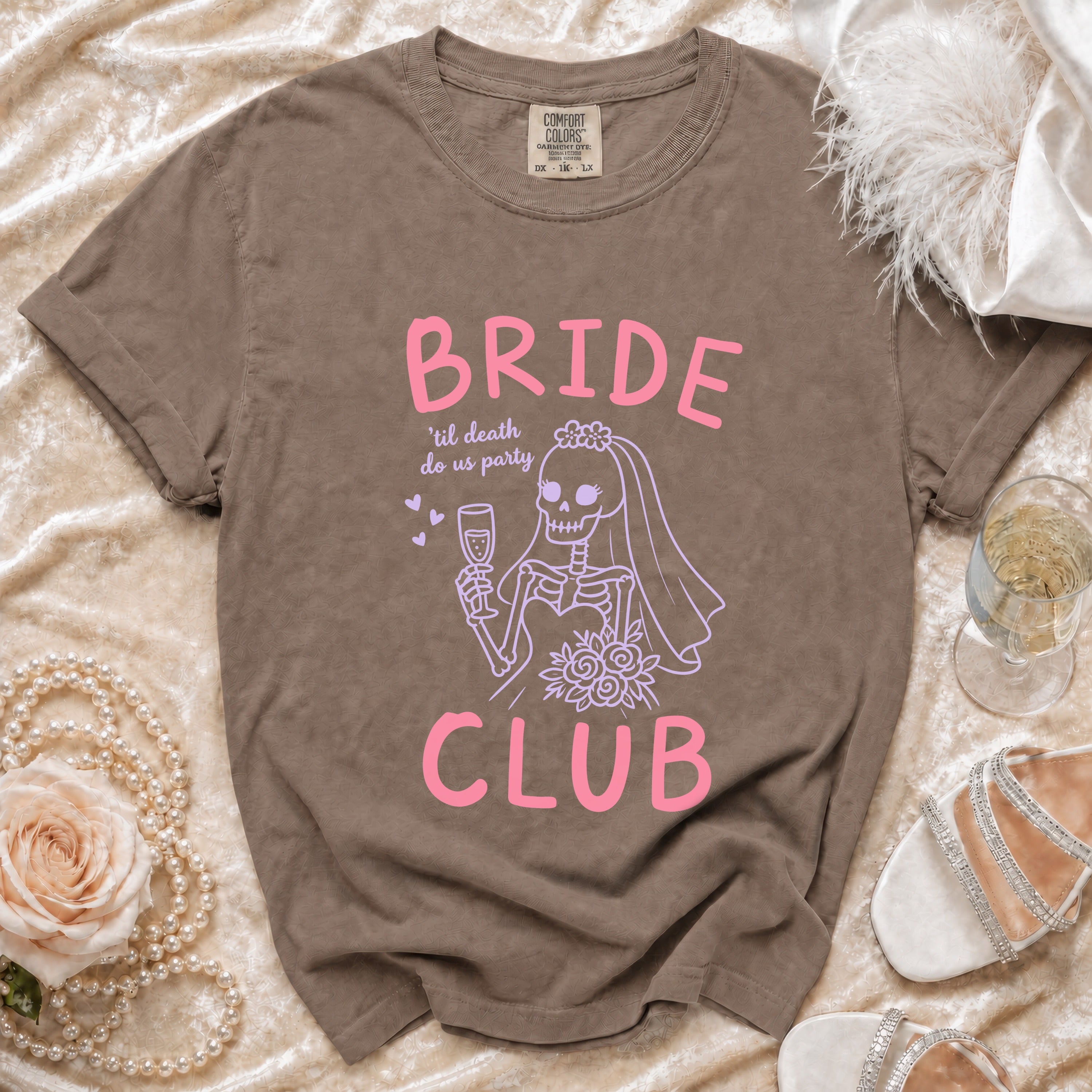 Brown t-shirt with pink "BRIDE CLUB 'til death do us party" text and skeleton bride graphic.