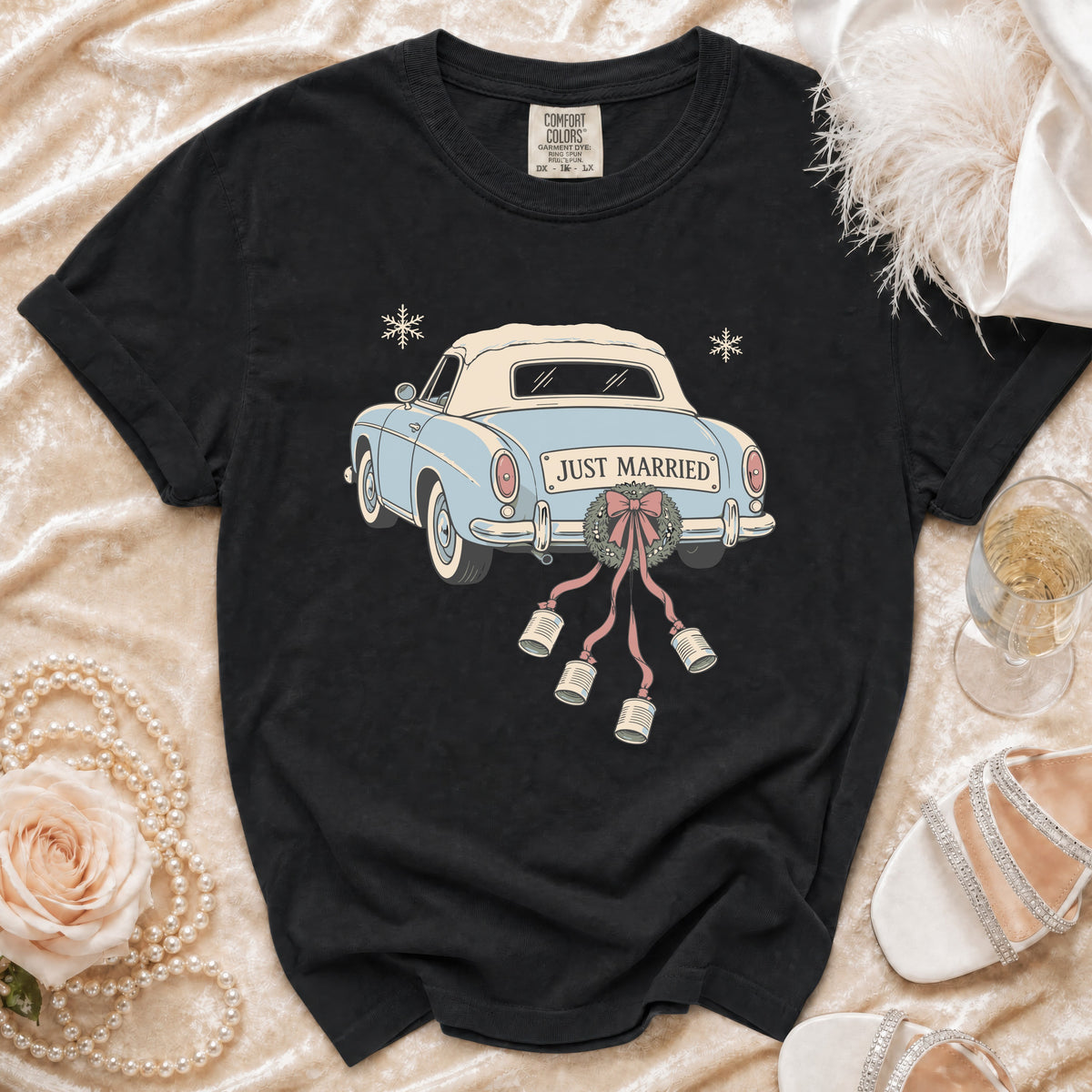 Black t-shirt with a light blue vintage car graphic that says "Just Married" and has cans tied to the back.