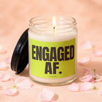 Candle with black lid and green label that reads "ENGAGED AF. VOWED."