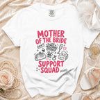 White t-shirt with "Mother of the Bride Support Squad" text and bridal icons.
