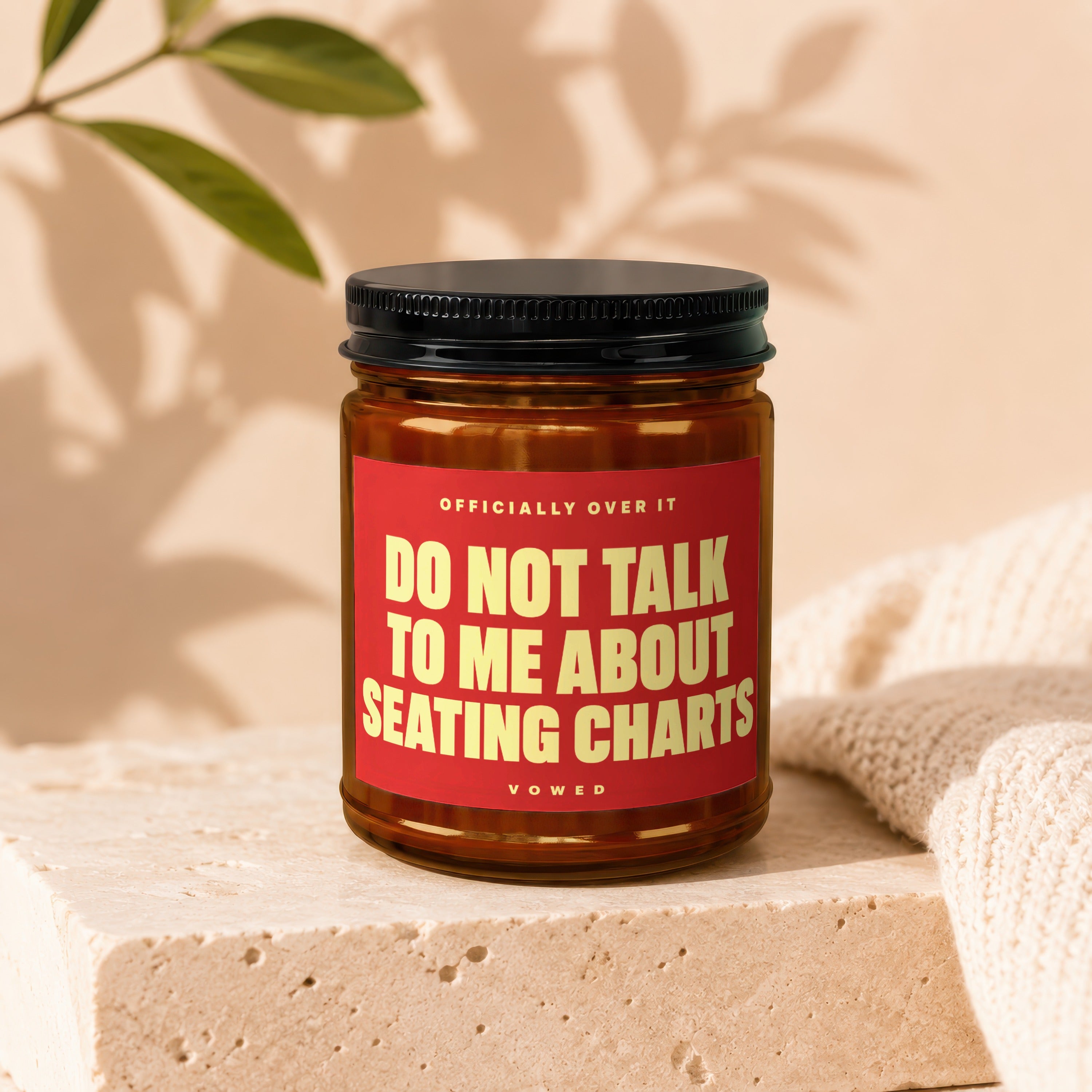 Brown jar with black lid, red label saying "Do Not Talk To Me About Seating Charts".