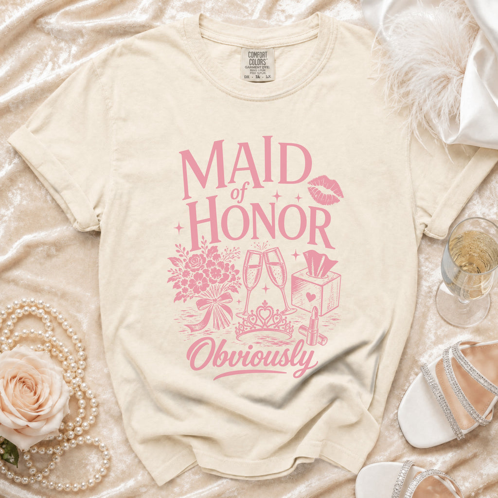 Light beige t-shirt with pink "Maid of Honor Obviously" graphic and wedding icons.