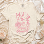 Light beige t-shirt with pink "Maid of Honor Obviously" graphic and wedding icons.