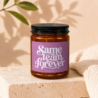 Amber jar candle with purple label that says "Same team forever" and "vowed".
