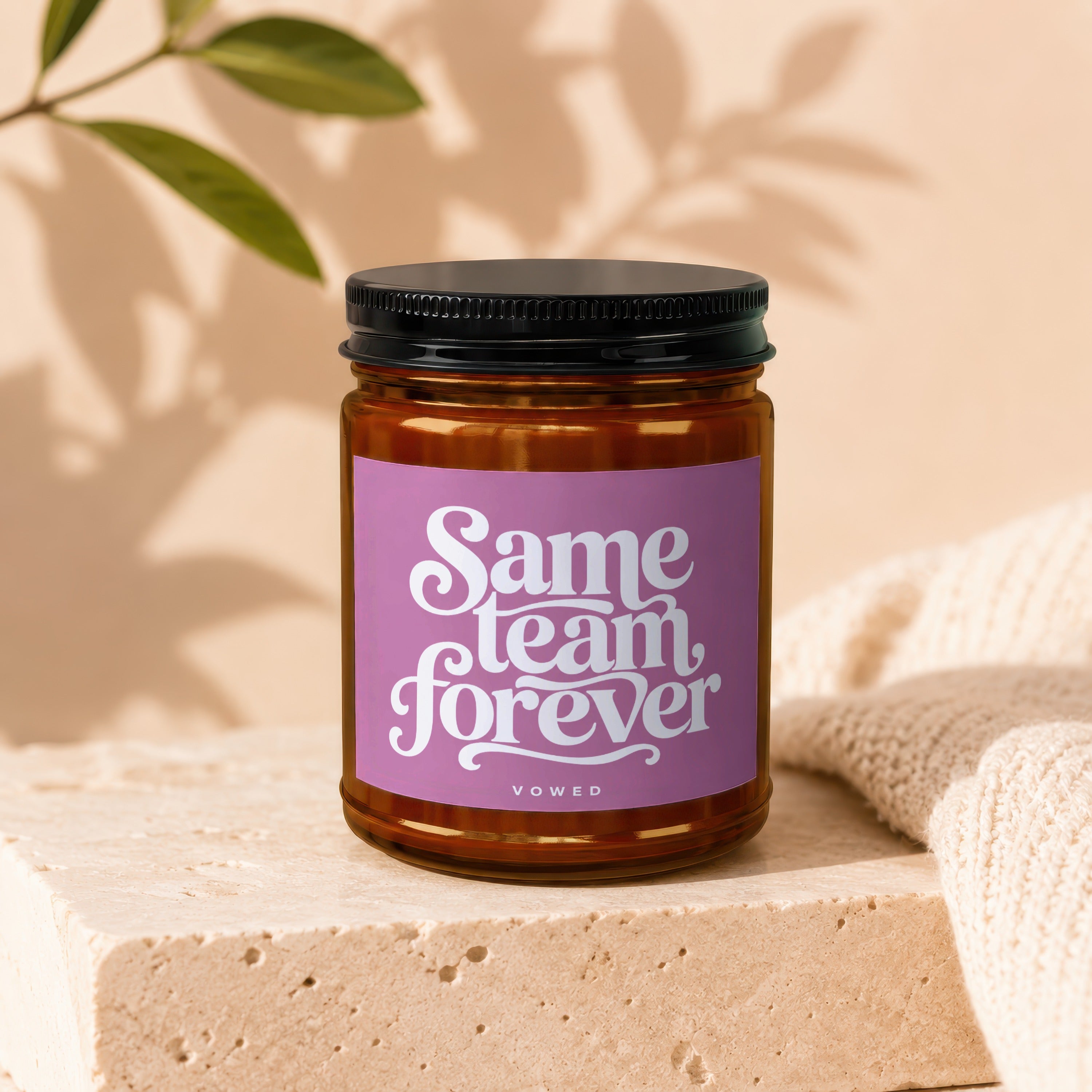 Amber jar candle with purple label that says "Same team forever" and "vowed".