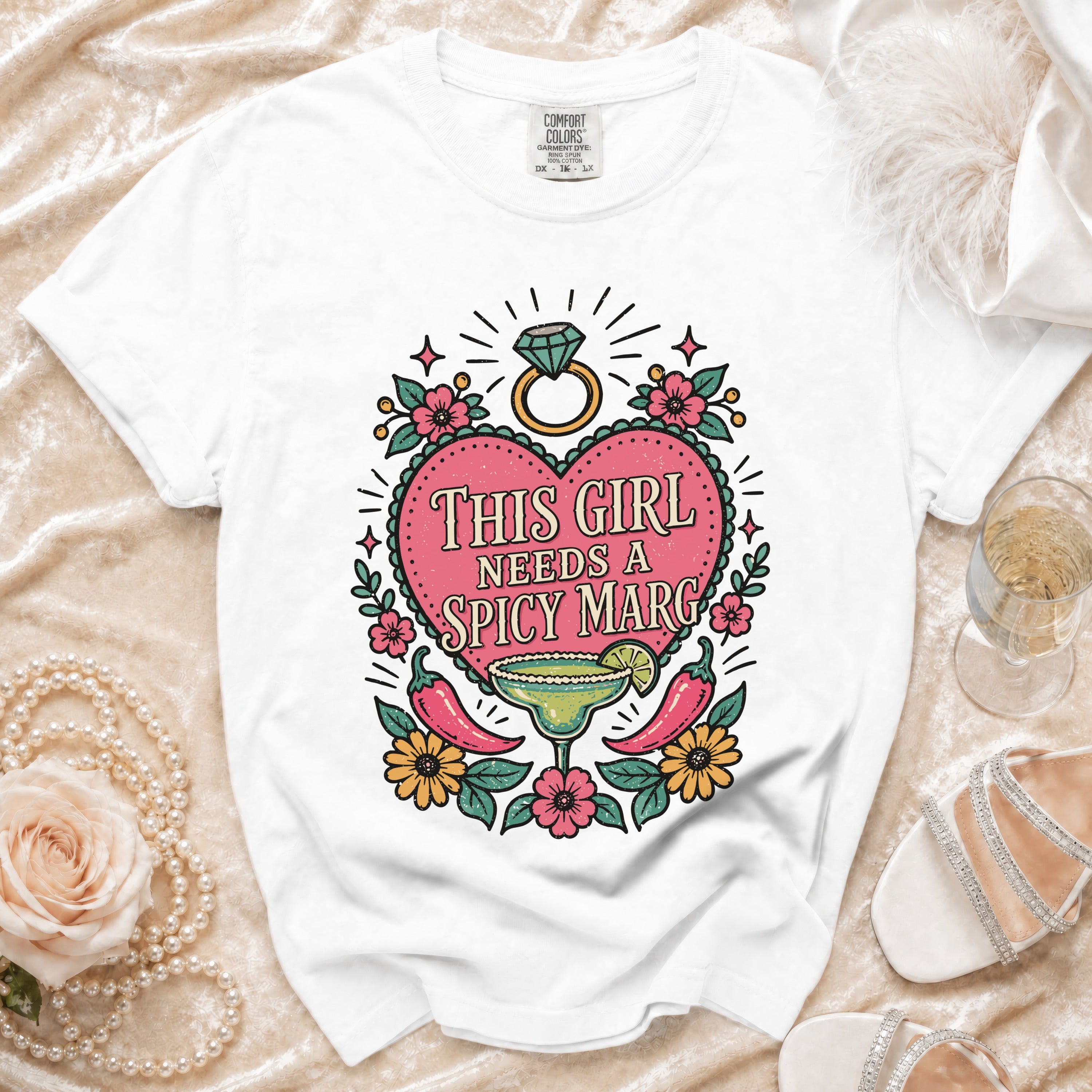 White t-shirt with "This Girl Needs a Spicy Marg" graphic featuring a margarita and peppers.