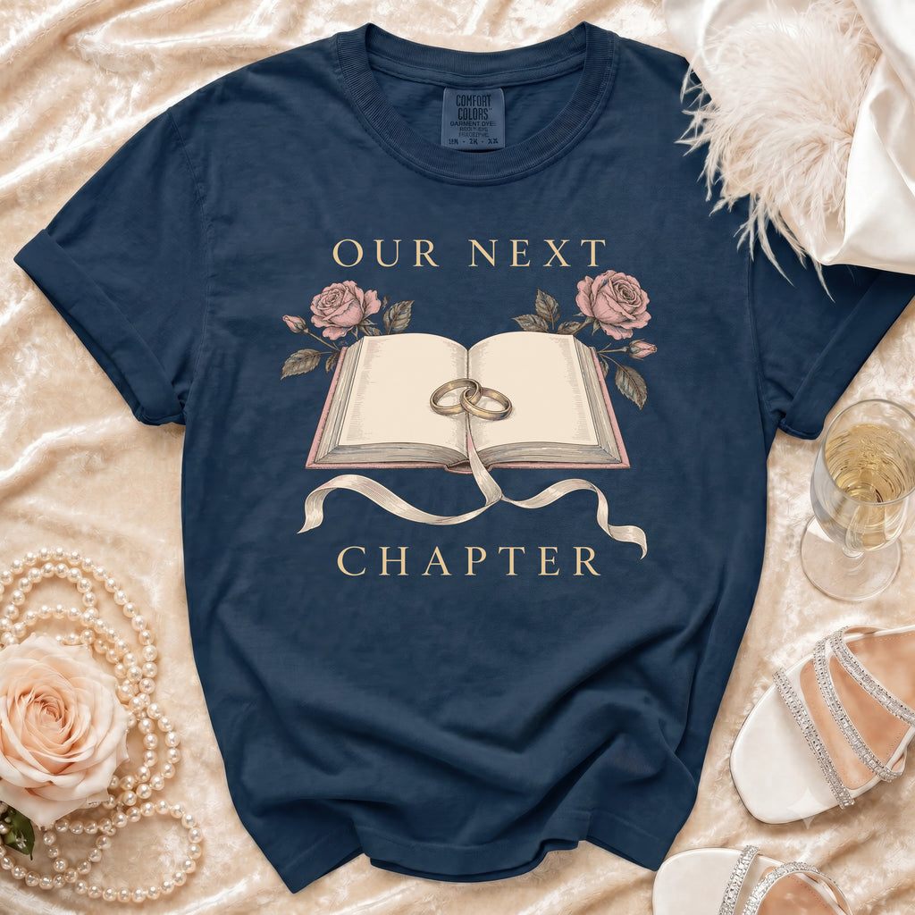 Navy t-shirt with open book, rings, roses, and text "Our Next Chapter".