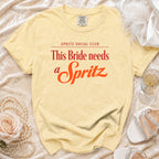Comfort Colors yellow t-shirt with "This Bride needs a Spritz" slogan.
