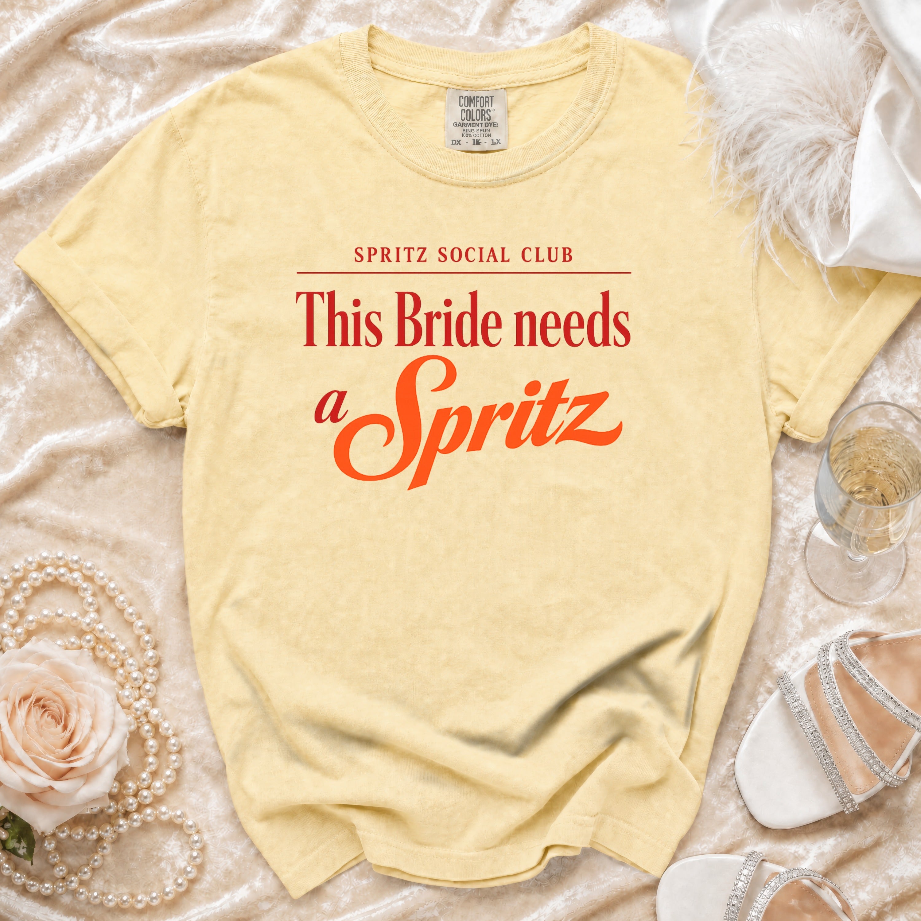 Comfort Colors yellow t-shirt with "This Bride needs a Spritz" slogan.