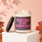 Glass candle with lit wick and black lid, featuring "Together Is My Favorite Place" text.