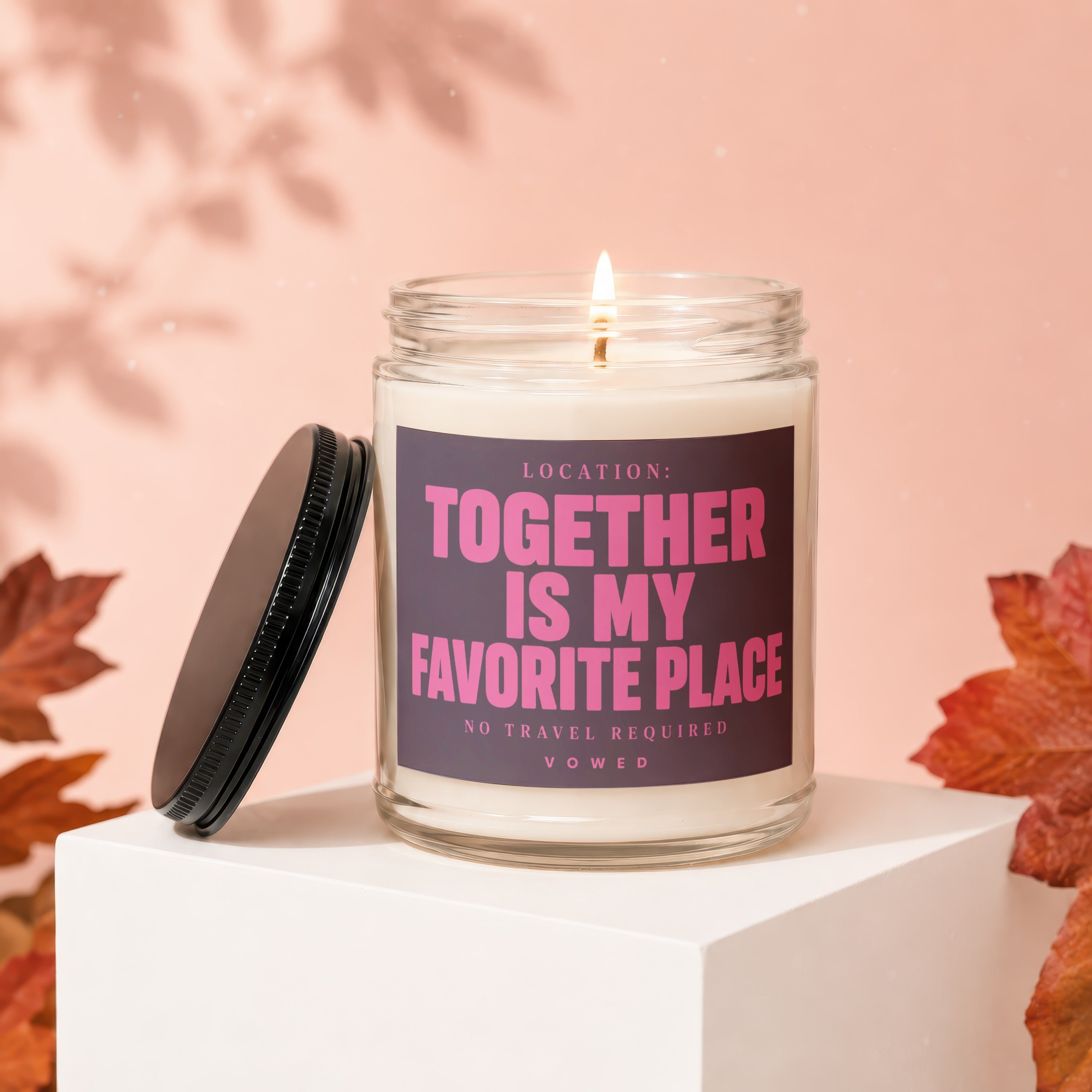Glass candle with lit wick and black lid, featuring "Together Is My Favorite Place" text.