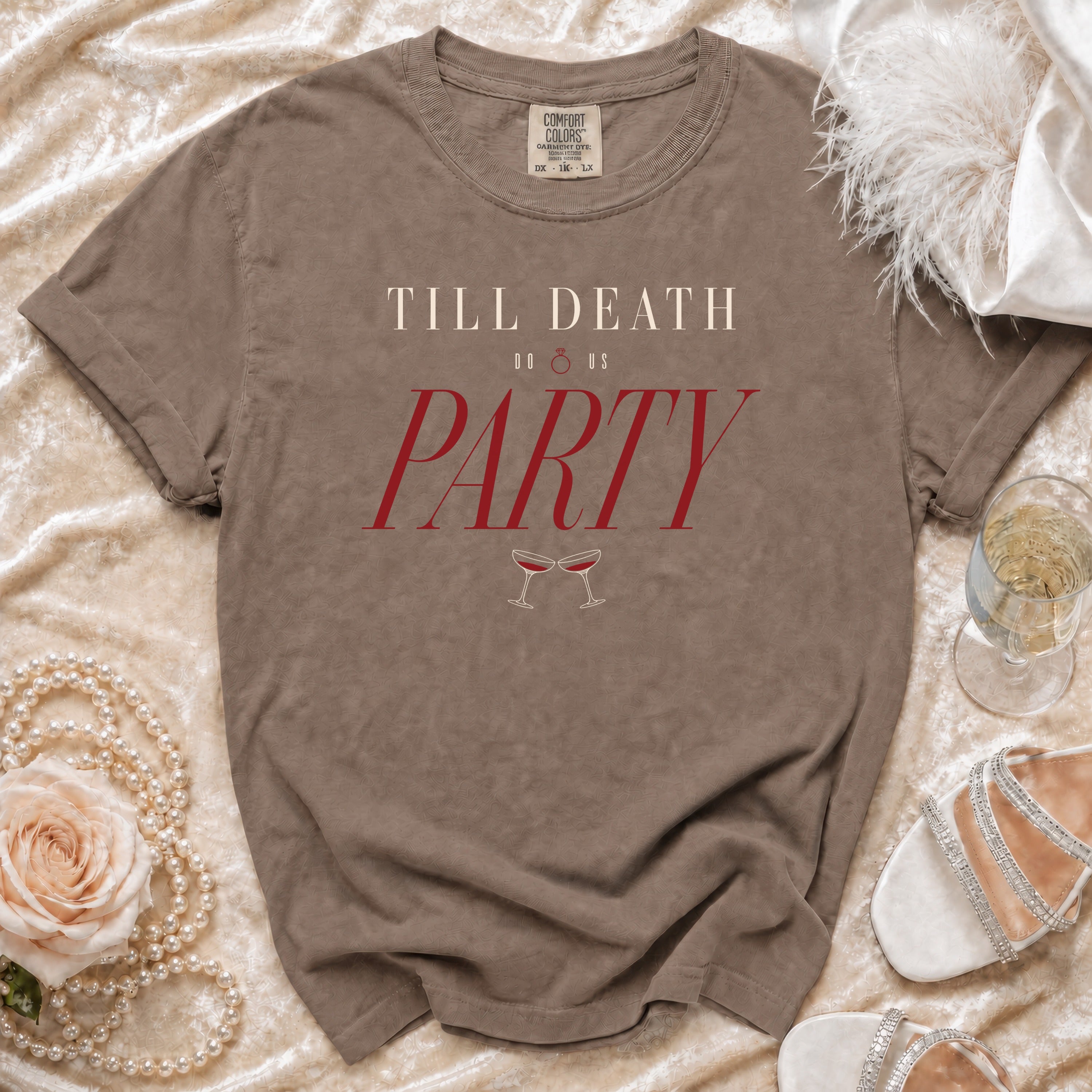 Brown t-shirt with "TILL DEATH DO US PARTY" text and champagne glasses.