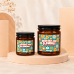 Two amber glass candles with floral labels reading "Engaged and Glowing".