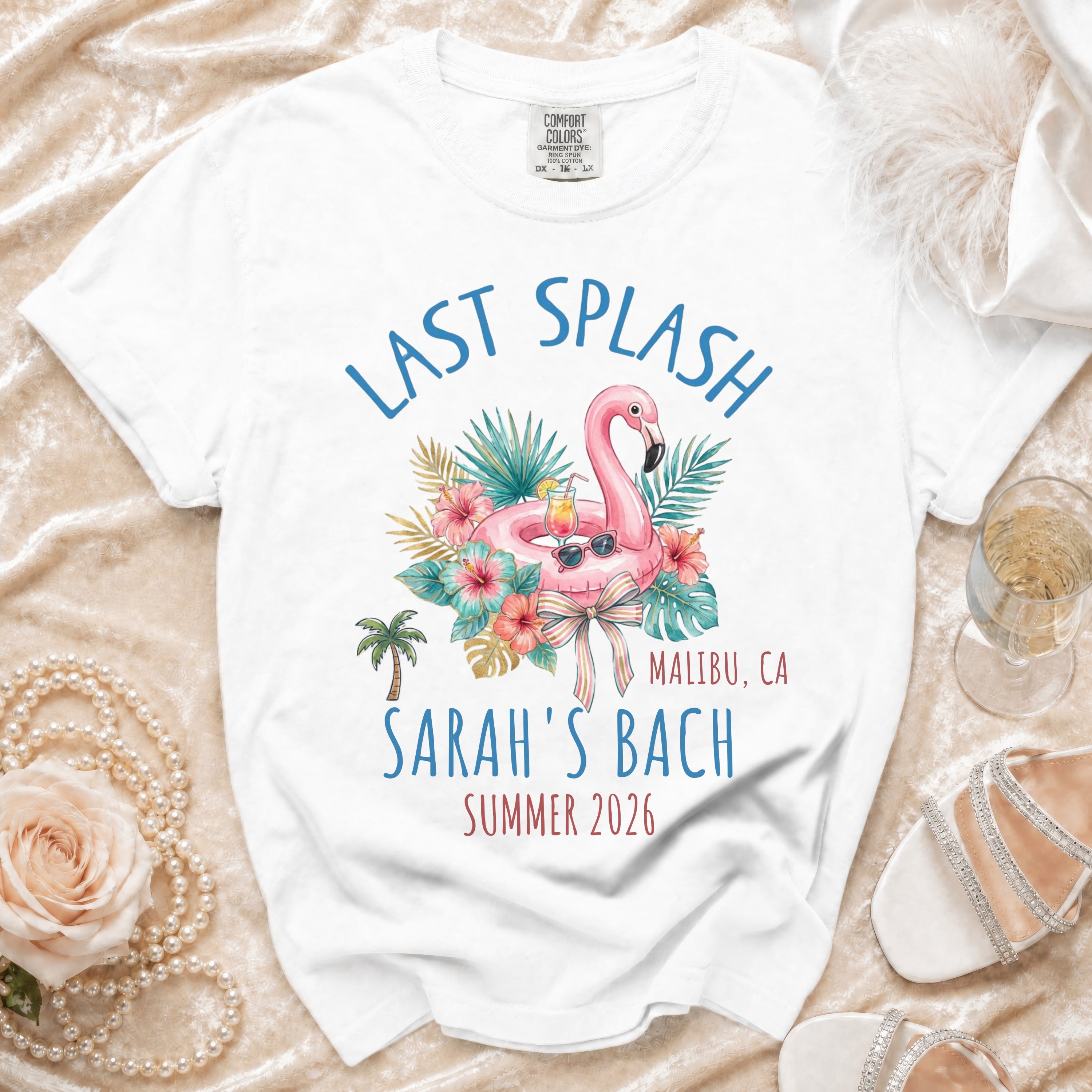 White t-shirt with "Last Splash Malibu, CA Sarah's Bach Summer 2026" text and flamingo graphic.