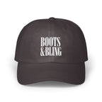 Dark grey dad hat with white embroidered text reading BOOTS & BLING on the front crown.