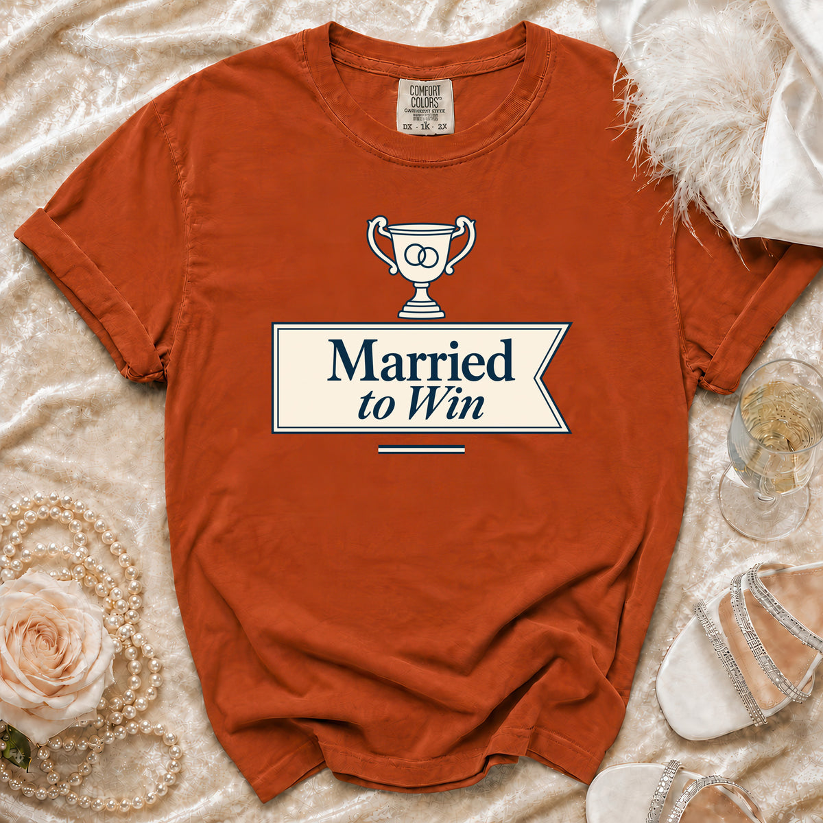 Orange t-shirt with "Married to Win" graphic and trophy symbol.