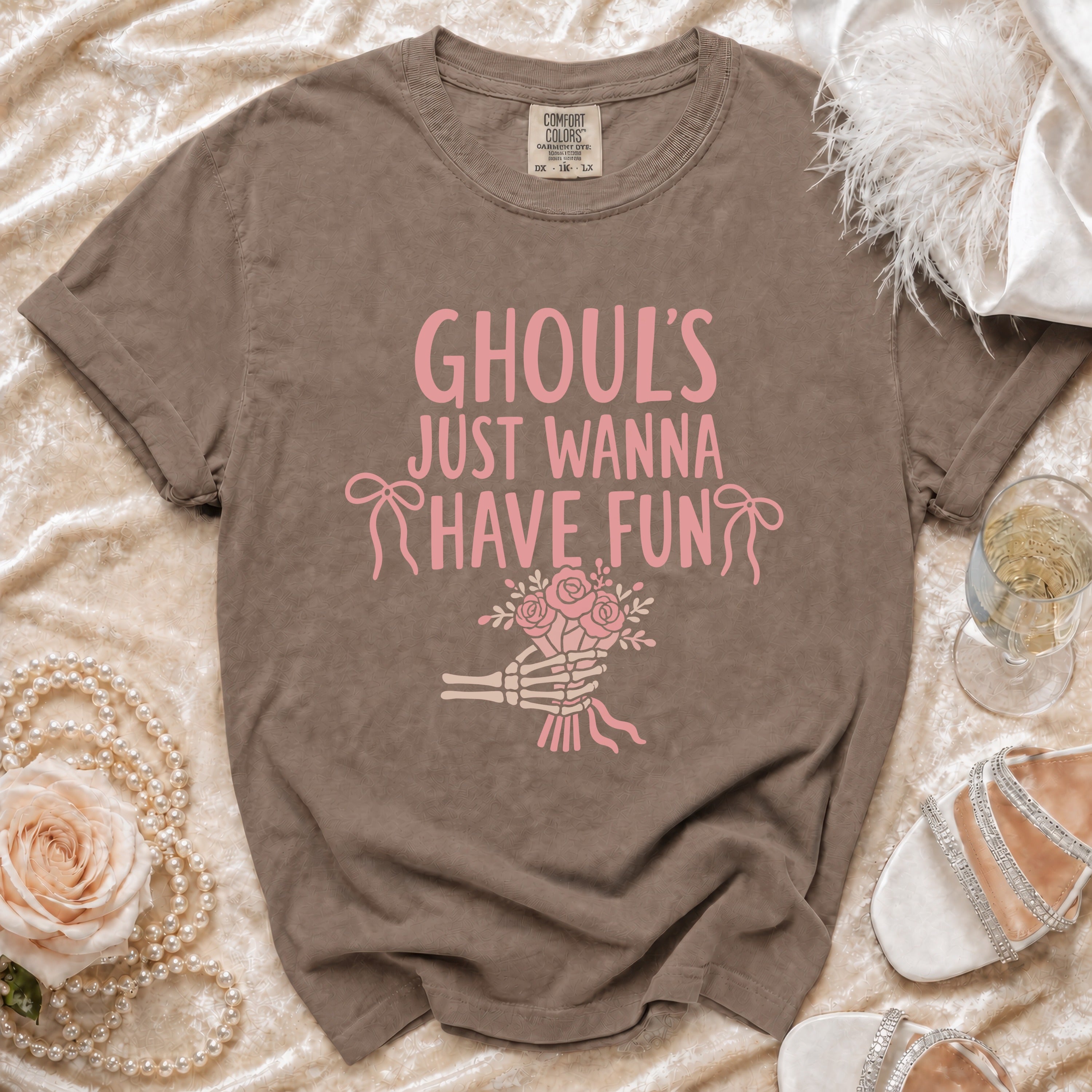 Brown t-shirt with pink "Ghoul's Just Wanna Have Fun" text and skeleton hand holding flowers.