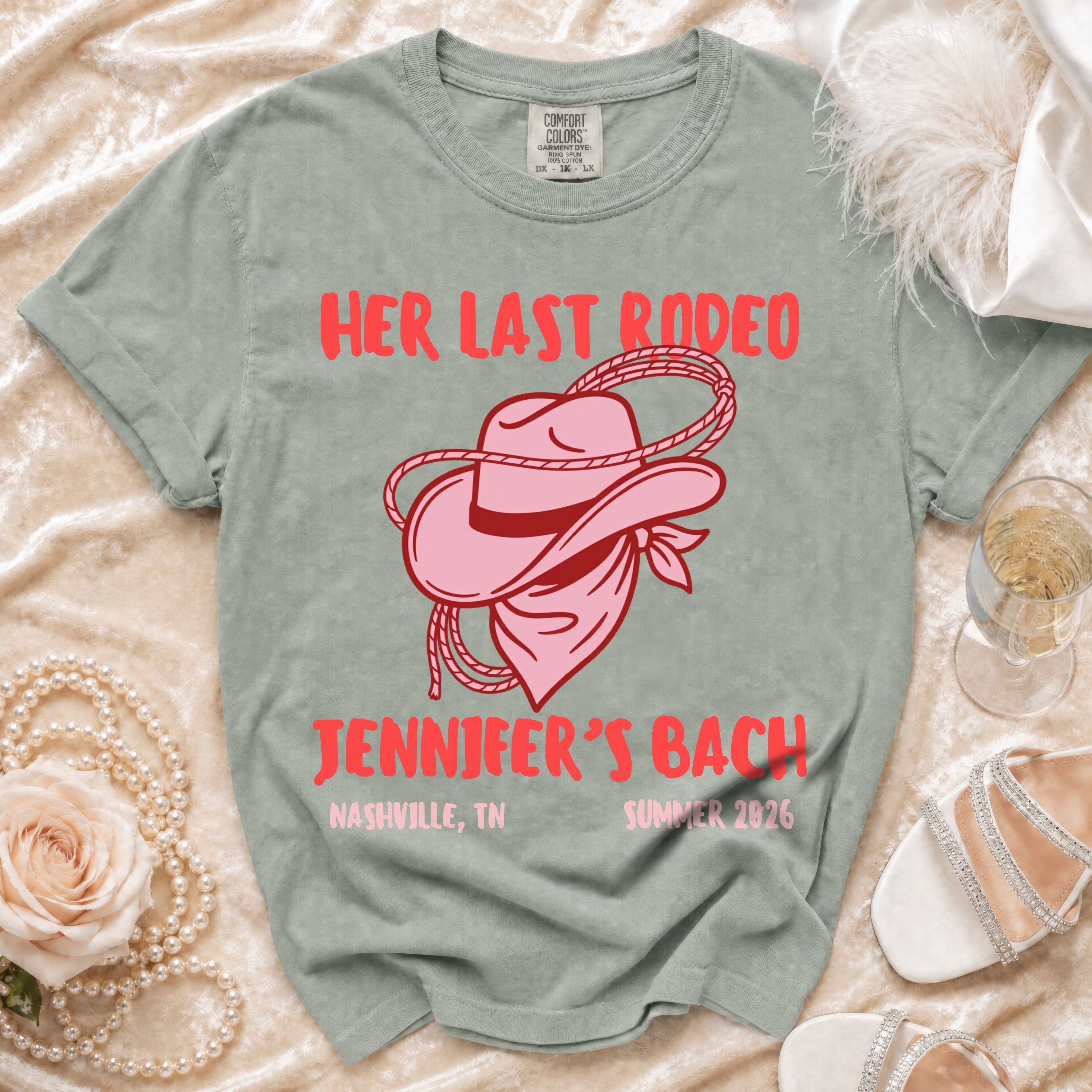 Pink cowboy hat and bandana graphic on gray t-shirt with text.