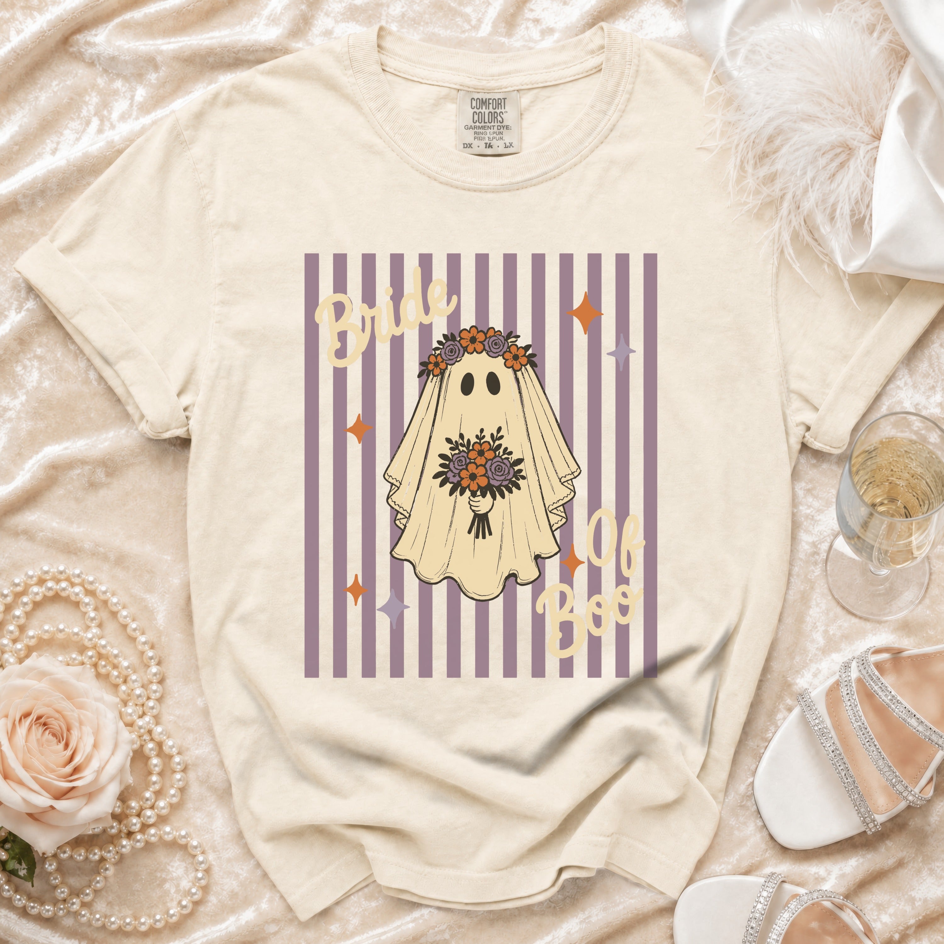 Cream t-shirt with "Bride of Boo" ghost graphic on purple stripes.