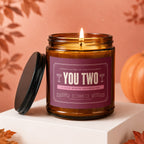 Amber glass candle with purple label, "YOU TWO" and "A love worth celebrating".