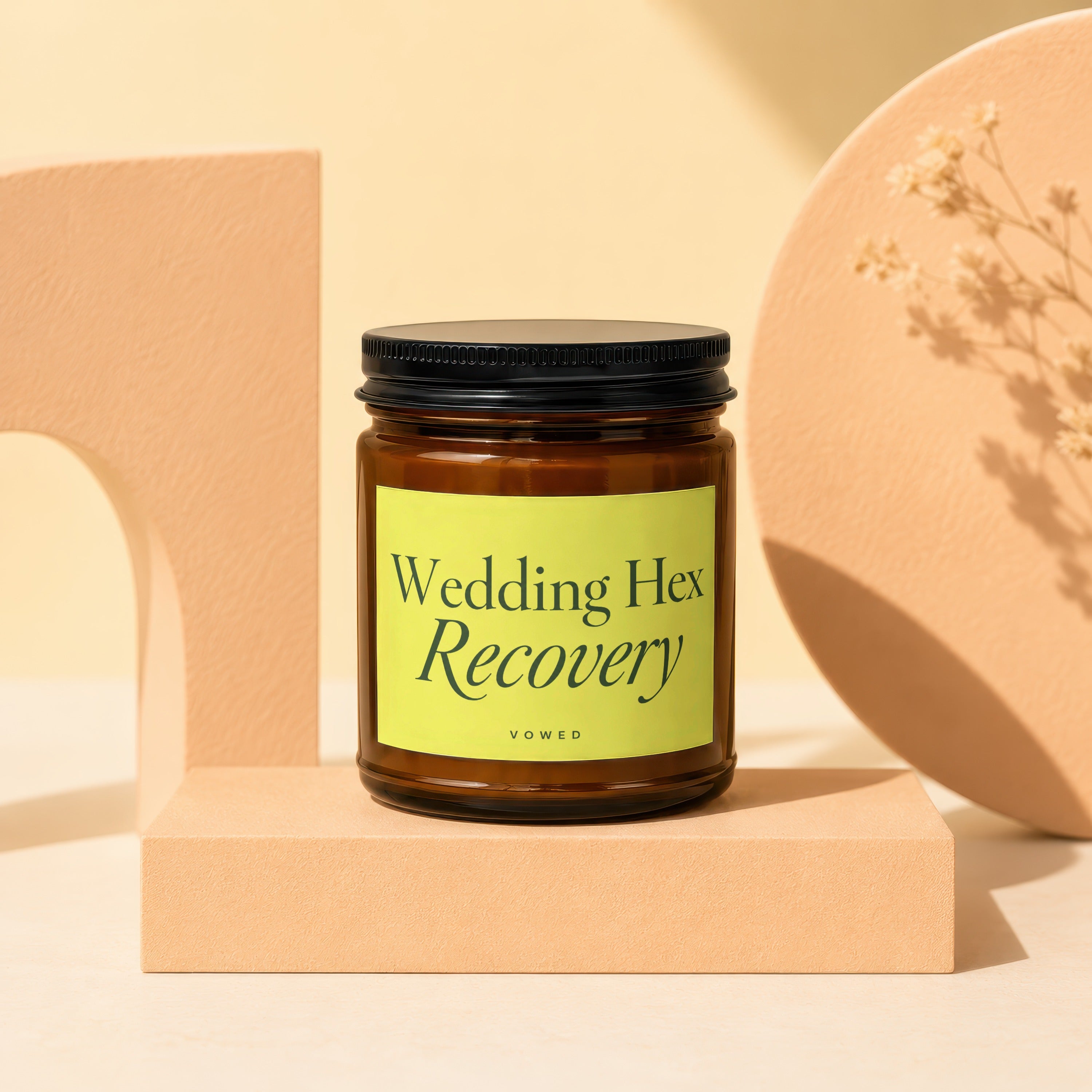 Amber jar candle with yellow label reading "Wedding Hex Recovery" and "VOWED".