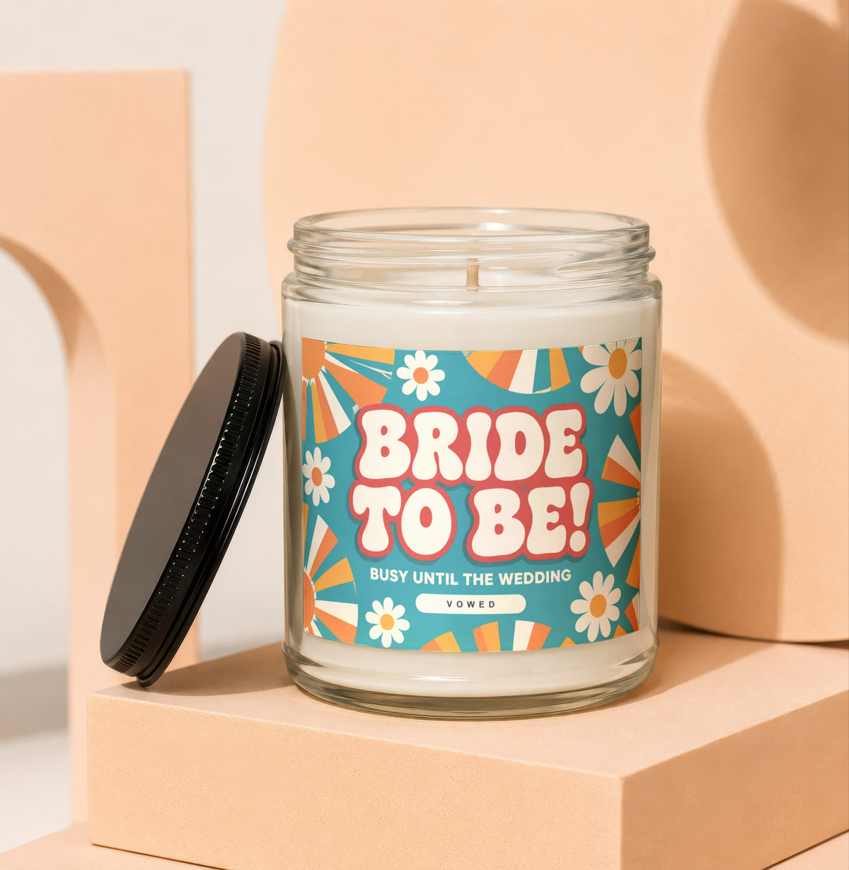 Glass candle with "Bride to Be! Busy Until The Wedding Vowed" label and floral design.