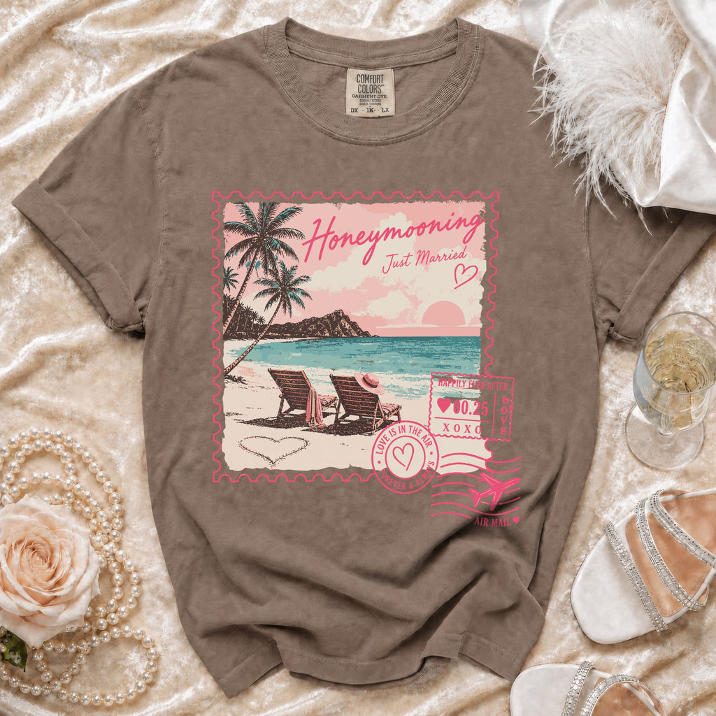 Brown t-shirt with "Honeymooning Just Married" tropical beach stamp graphic.
