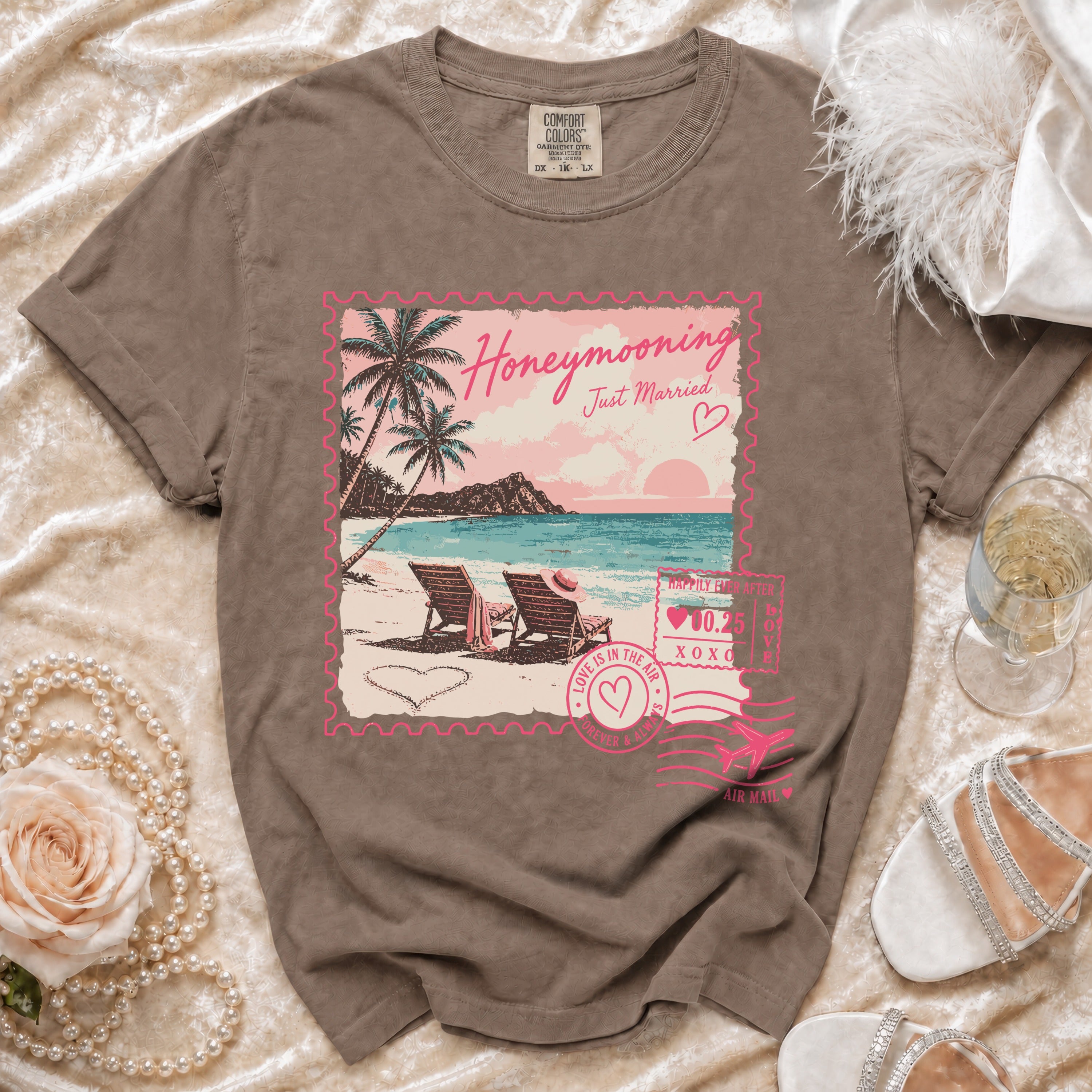 Brown t-shirt with "Honeymooning Just Married" tropical beach stamp graphic.