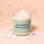 Lit candle in a glass jar with text "The Bride Is Allowed to Cry" and "VOWED".