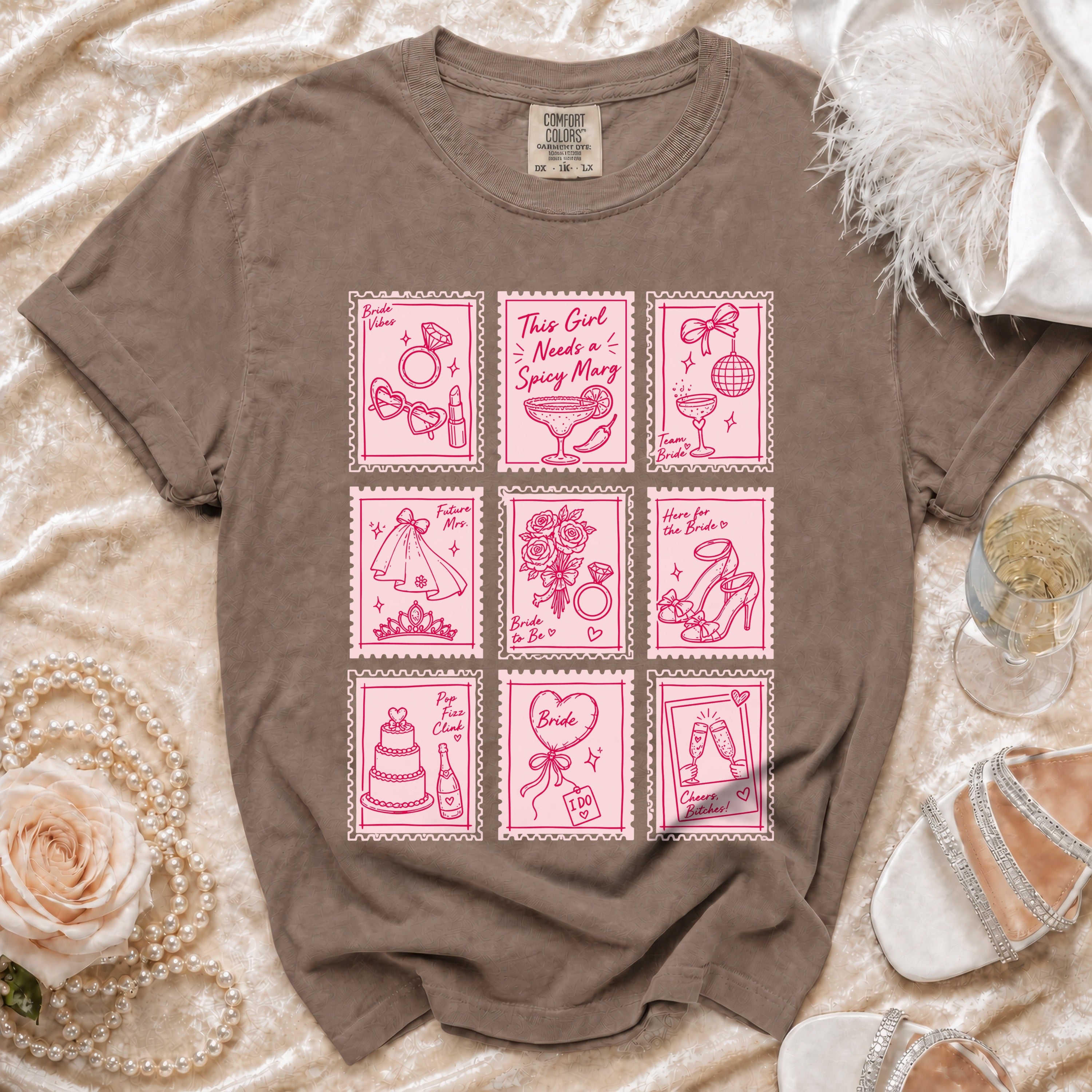 Brown t-shirt with pink "bridal stamp" style graphics featuring rings, margaritas, and wedding items.