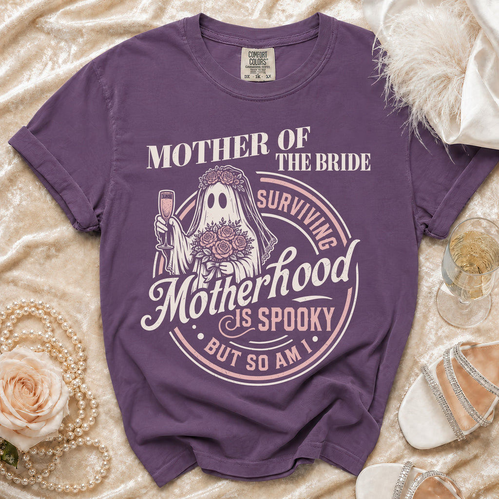Purple t-shirt with "Mother of the Bride Surviving Motherhood is Spooky But So Am I" graphic.