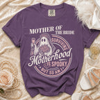 Purple t-shirt with "Mother of the Bride Surviving Motherhood is Spooky But So Am I" graphic.