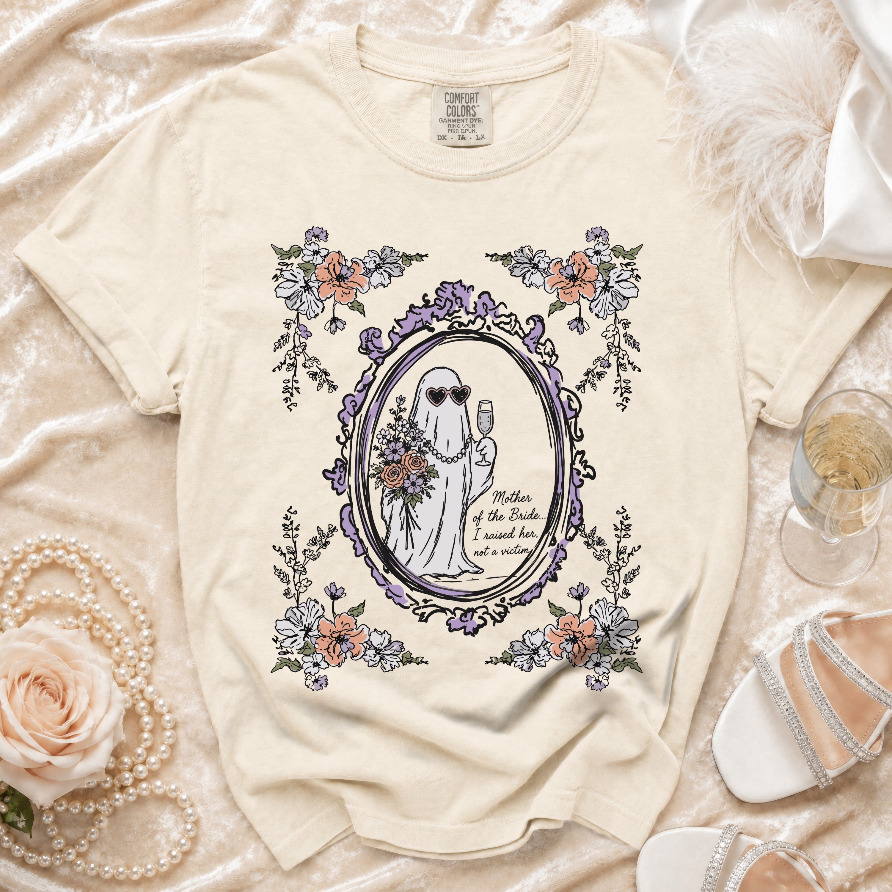 Cream t-shirt with a ghost graphic holding flowers and champagne, saying "Mother of the Bride... I raised her, not a victim".