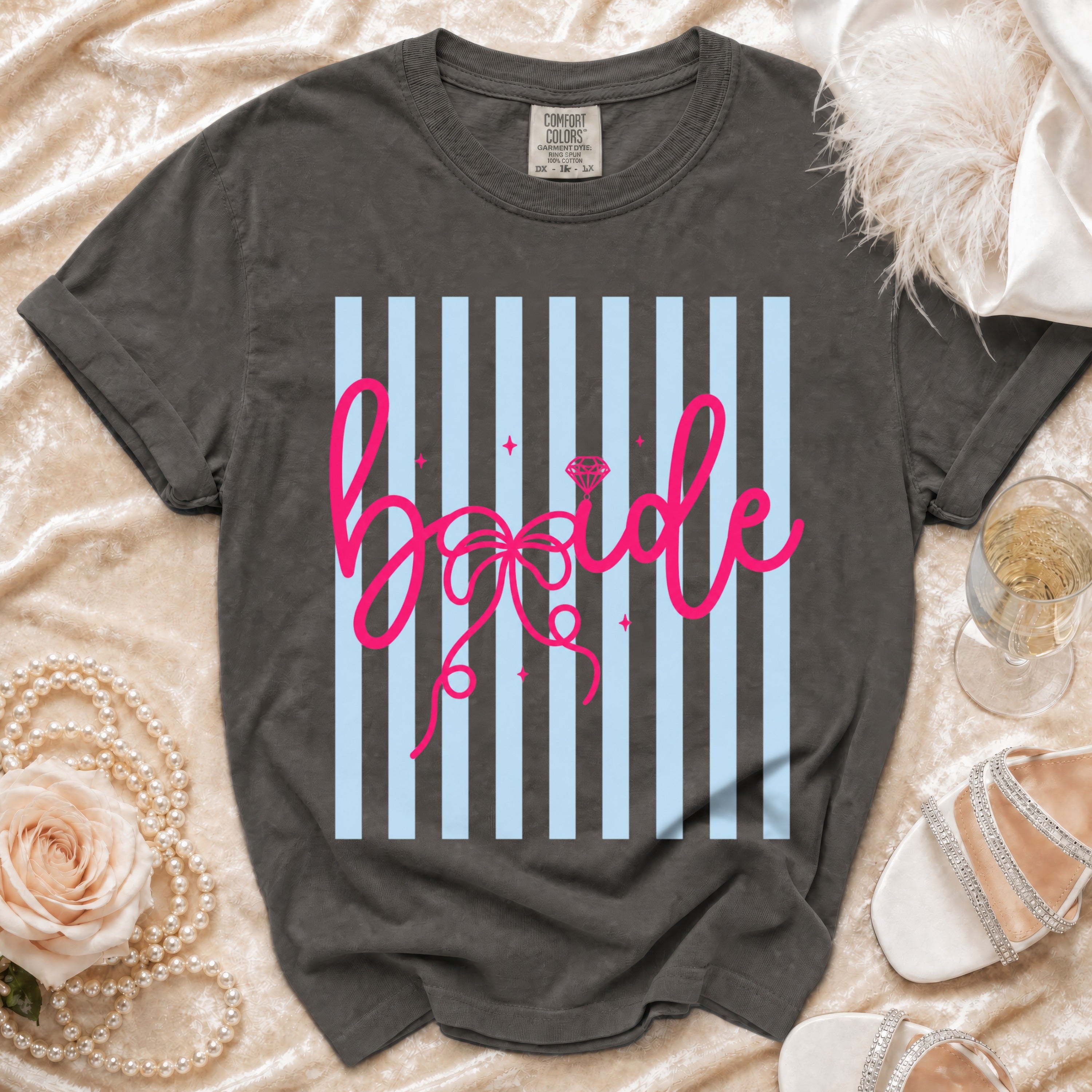 Dark gray t-shirt with "Bride" in pink cursive on blue and gray stripes.