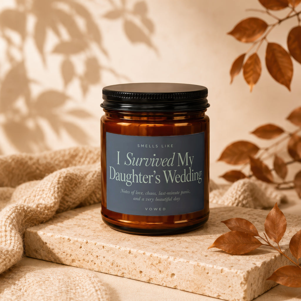 Amber glass candle with text "I Survived My Daughter's Wedding".
