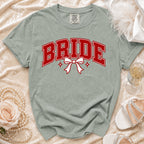 Light grey t-shirt with "BRIDE" text in red, featuring a white bow.