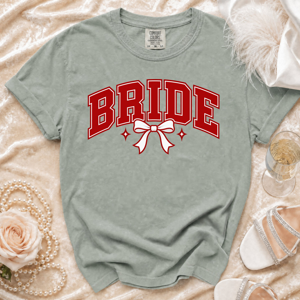 Light grey t-shirt with "BRIDE" text in red, featuring a white bow.