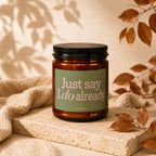 Amber jar candle with "Just say I do already" text on a green label.