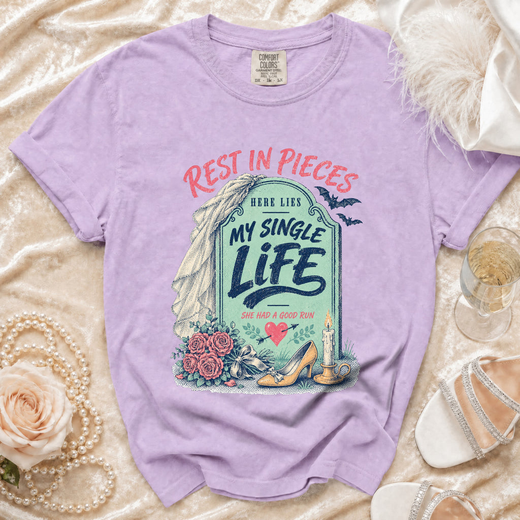 Purple t-shirt with "Rest in Pieces, Here Lies My Single Life" tombstone design.