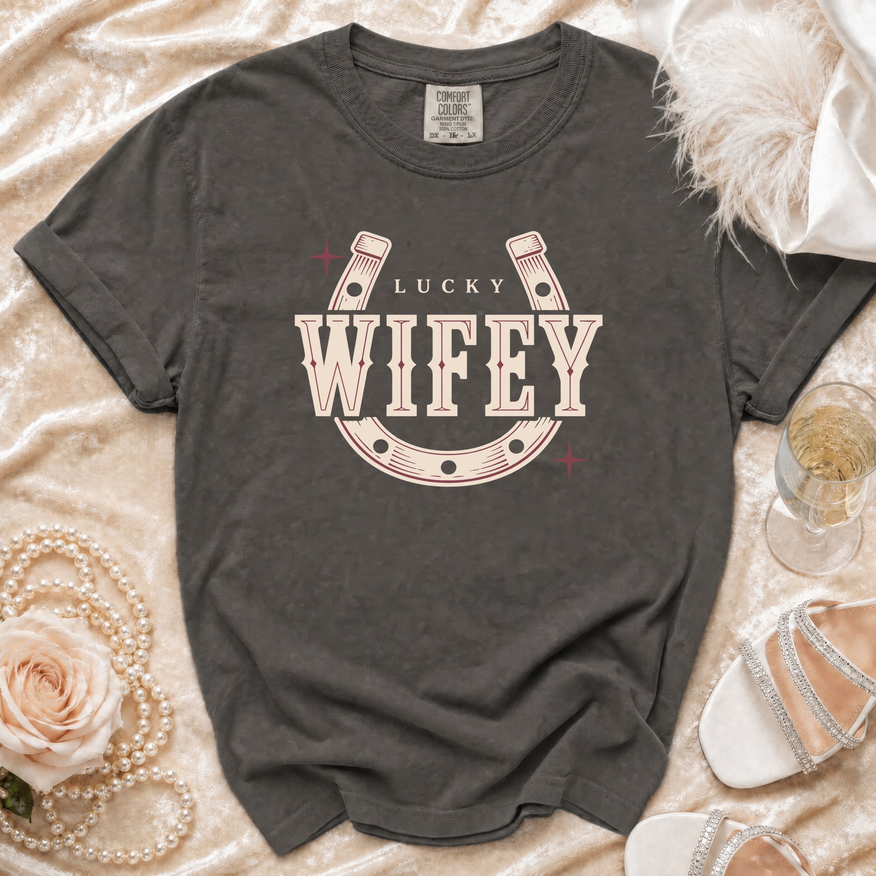 Dark gray t-shirt with "Lucky Wifey" text and horseshoe graphic.