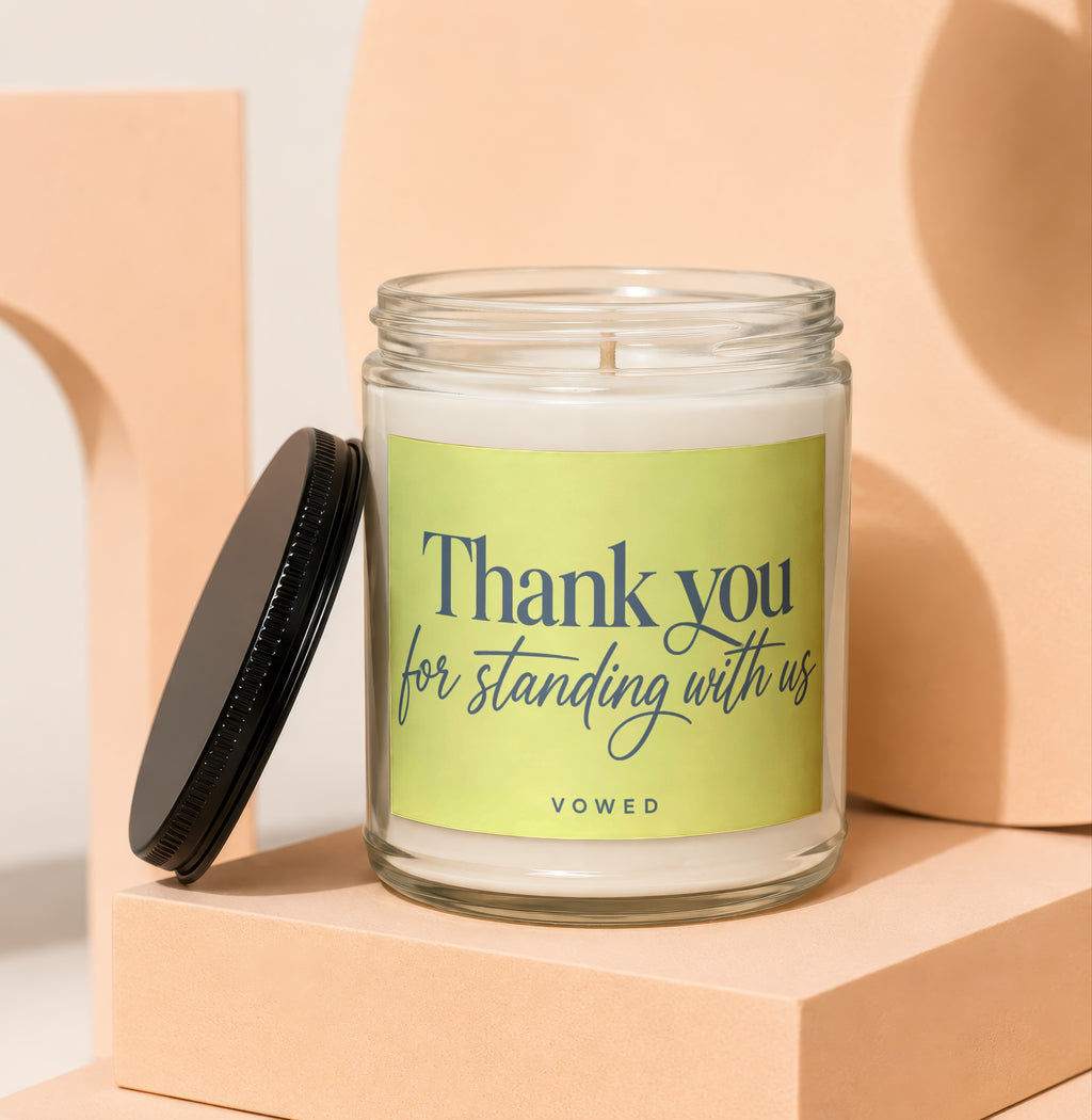 Glass candle with black lid and label reading "Thank you for standing with us"