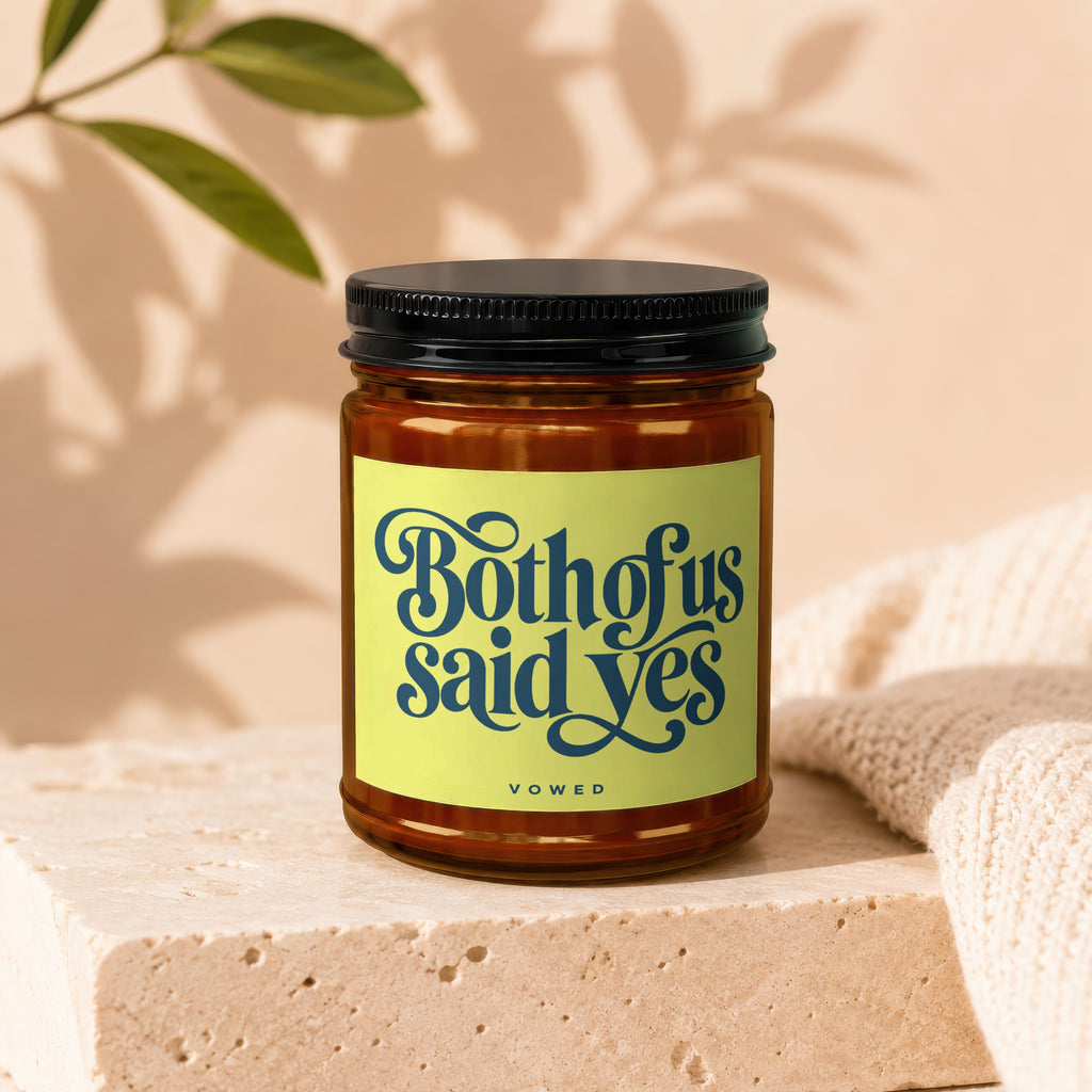 Candle with "Both of us said yes" and "VOWED" text on a lime green label.