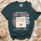 Dark teal t-shirt with "Mother of the Groom" text, envelope graphic, and roses.