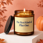 Amber jar candle with lid removed, lit wick, and text "The Best Kind of Plus One. VOWED."