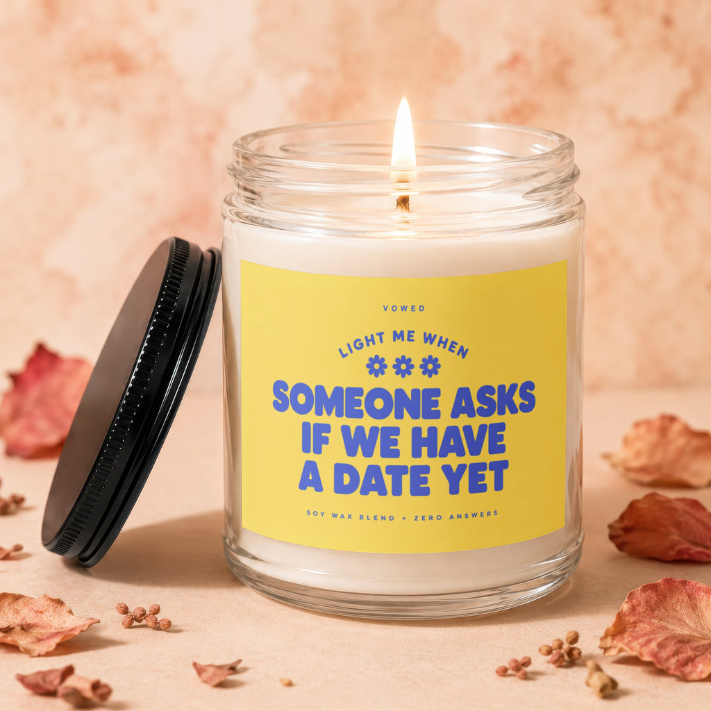 Candle with label "Light me when someone asks if we have a date yet"