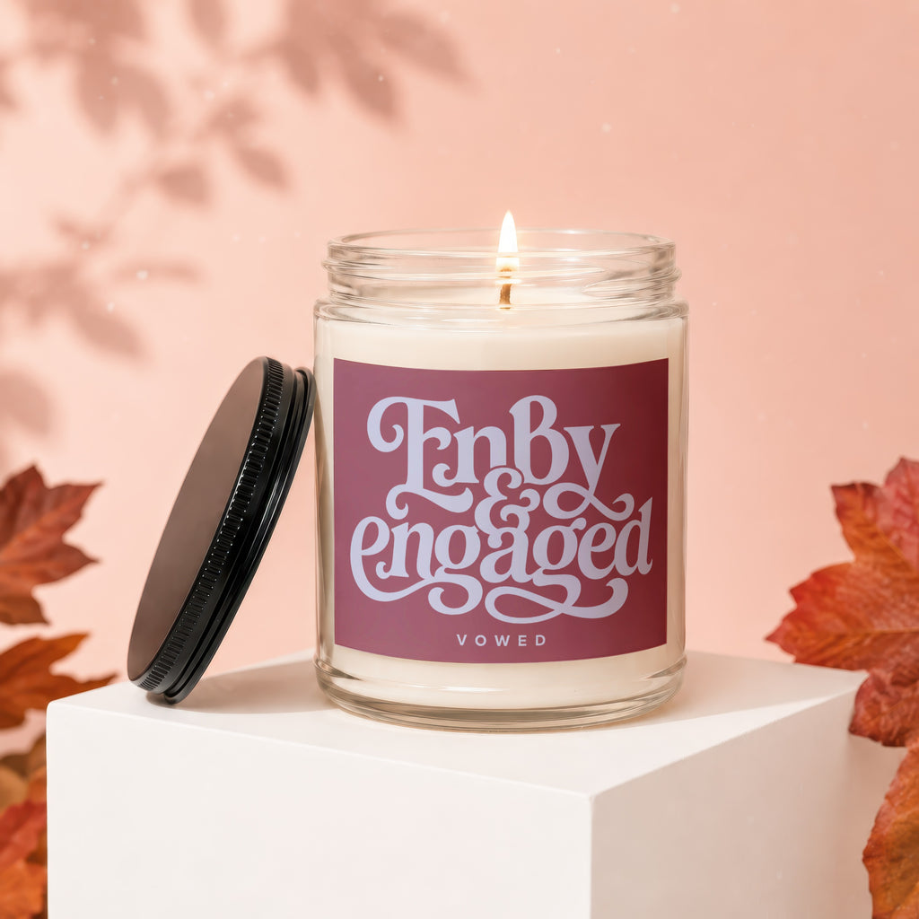 Glass candle with label reading "Finally Engaged" and "VOWED" on pink background.