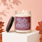 Glass candle with label reading "Finally Engaged" and "VOWED" on pink background.