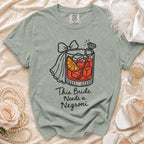 Light green t-shirt with graphic of a negroni, ring, and text "This Bride Needs a Negroni".