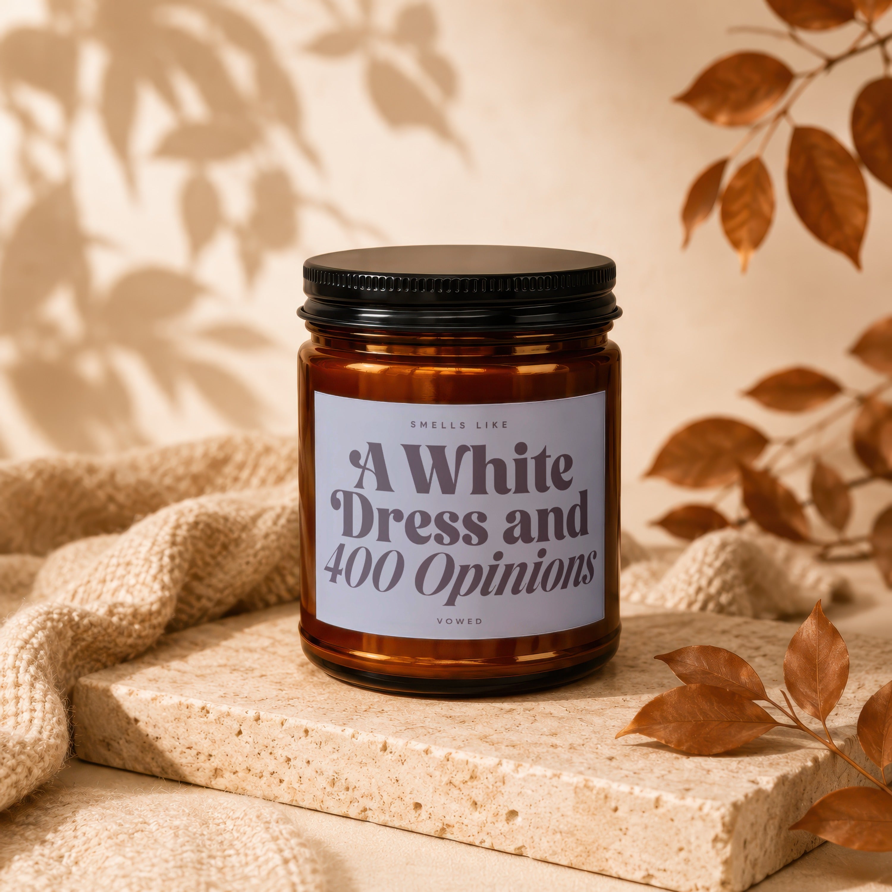 Amber candle with dark lid labeled "A White Dress and 400 Opinions".