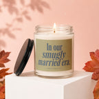 Candle on white cube with text "In our smugly married era."